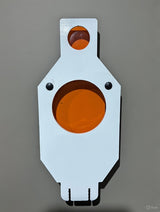 White metal shooting target with an orange circular bullseye in the center and a smaller orange circle near the top against a gray background.