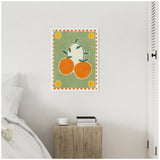 Framed canvas with two large bright orange fruits and green leaves on a muted green background, bordered by orange and white checkered pattern and yellow sun motifs.