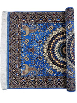 Hand-knotted Afghan wool rug with vibrant sky blue field, intricate floral patterns, and dark border, partially rolled to reveal fringed edge.