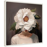 Portrait of a person with a large white flower covering their face, set against a dark background with green leaves, and wearing a light-colored top.