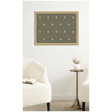 Minimalist living room with two white armchairs and a small brass side table, featuring a framed green botanical block print with small white floral motifs on the wall.