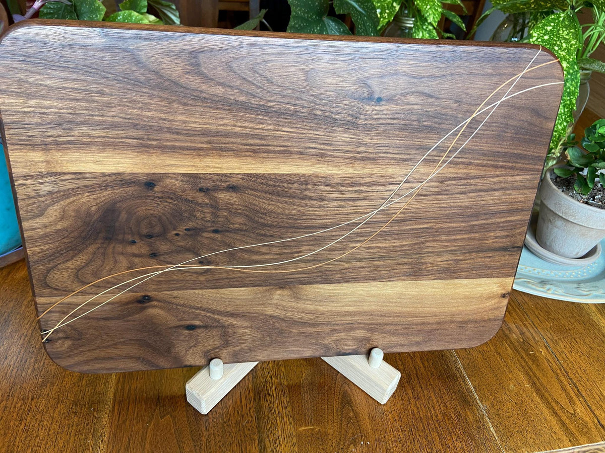 Walnut charcuterie board with Cherry and Maple decorative banding, handcrafted by Fitzgerald Custom Woodcraft