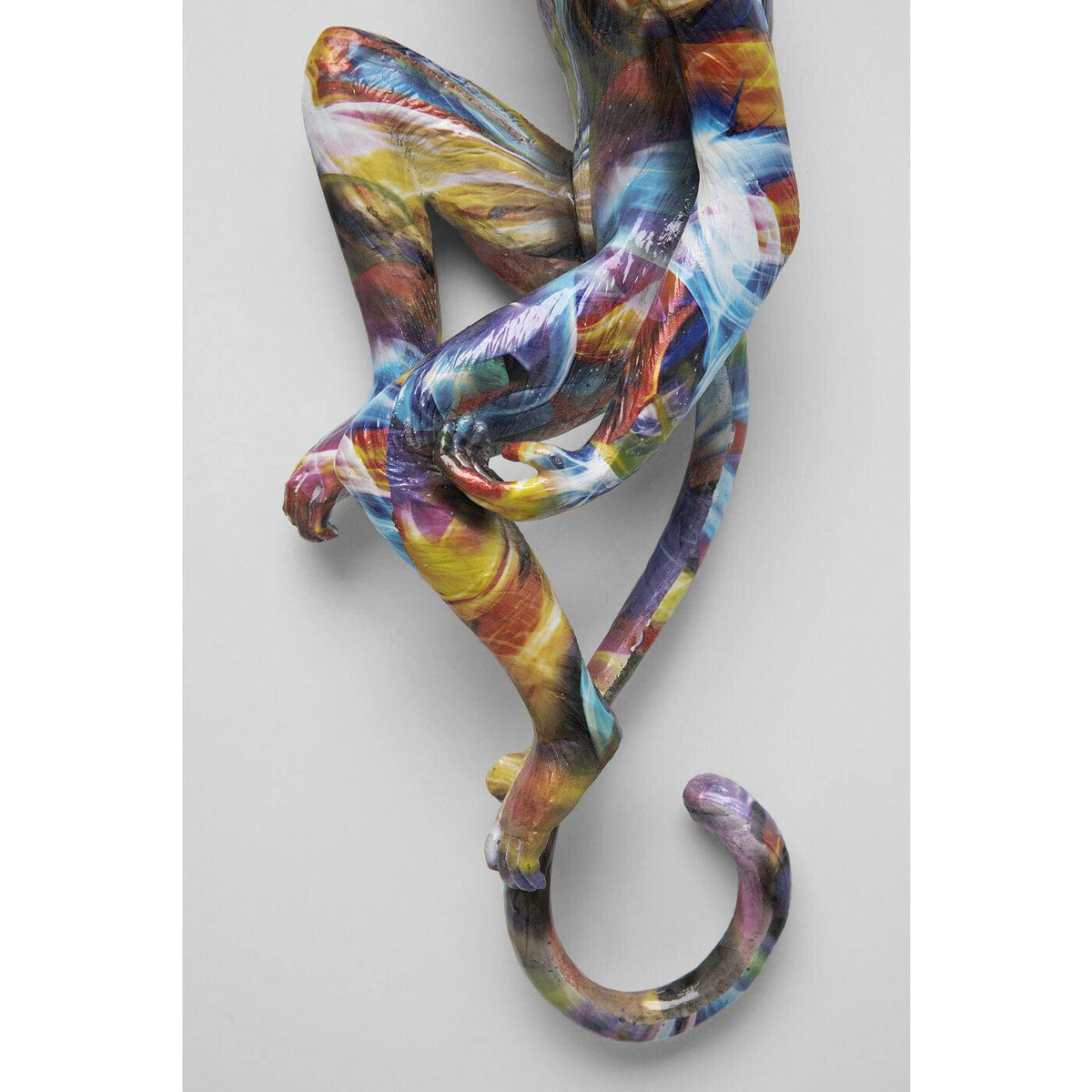 Sculpted ape wall hanging with vibrant multicolor brushstroke patterns in blue, yellow, red, and white, measuring 17x67cm, shown against a plain gray background.