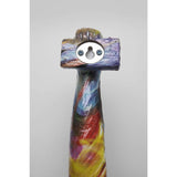 Colorful sculpted arm and clenched fist wall object with a metal keyhole hanging fixture on the back, featuring swirling hues of blue, red, yellow, and purple.