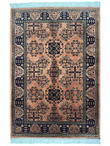 Hand-Knotted Bukharayi Rug in peach, red, ivory, and gold tones with traditional Afghan wool design, displayed on wooden floor