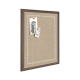 Rectangular beige fabric pinboard with a dark brown wooden frame and white scalloped-edge decorative border, holding two black-and-white photos pinned at the top left corner.