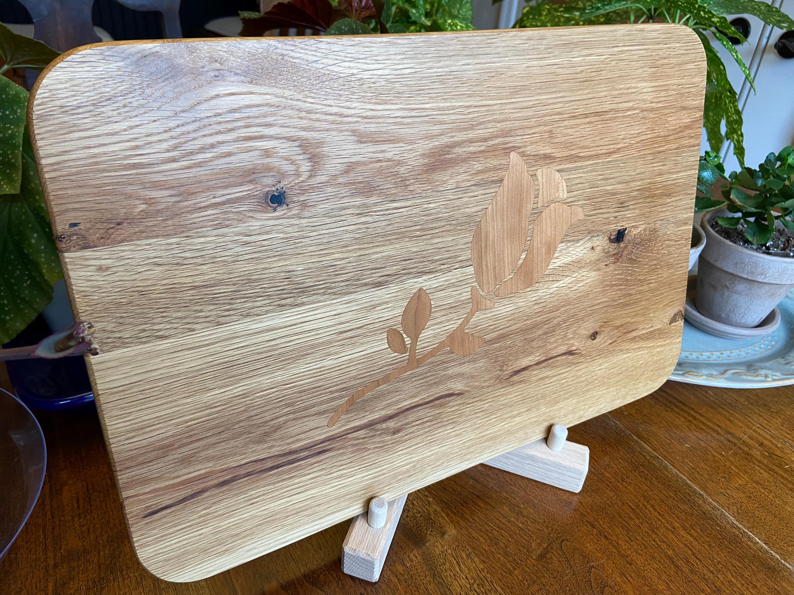 White Oak charcuterie board with subtle Cherry rose and stem inlay, handcrafted by Fitzgerald Custom Woodcraft