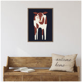 Framed canvas of a stylized brown and white cow wearing red glasses on a dark navy background above a wooden bench with an open book and a beige pillow with 'welcome home' text.