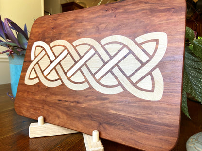 Cherry charcuterie board with complex Celtic knot inlay on White Oak wood