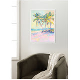 Framed pastel-colored oil painting of five palm trees near a beach with ocean waves, hanging above a dark olive armchair draped with a white knitted throw.