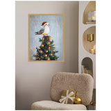 Framed canvas of a seagull wearing a red Santa hat perched atop a decorated Christmas tree with glowing lights, hanging on a beige wall above a cozy textured chair.