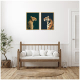 Two framed canvases above a wooden bench depict a gold and black leopard on emerald green and a navy and orange tiger on dark blue backgrounds.