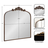 Arched rectangular mirror with an antique bronze frame, featuring an ornate crown detail at the top and D-ring hangers on the back, measuring 28 by 30 inches.