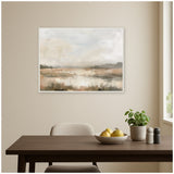 Neutral-toned abstract landscape wall art featuring soft brown and beige fields under a light gray sky, framed and hung above a wooden dining table with fruit bowl and plant.