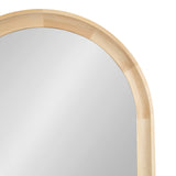 Close-up of an arched wall mirror with a smooth, light wood frame featuring natural grain variations and a seamless curved top edge.