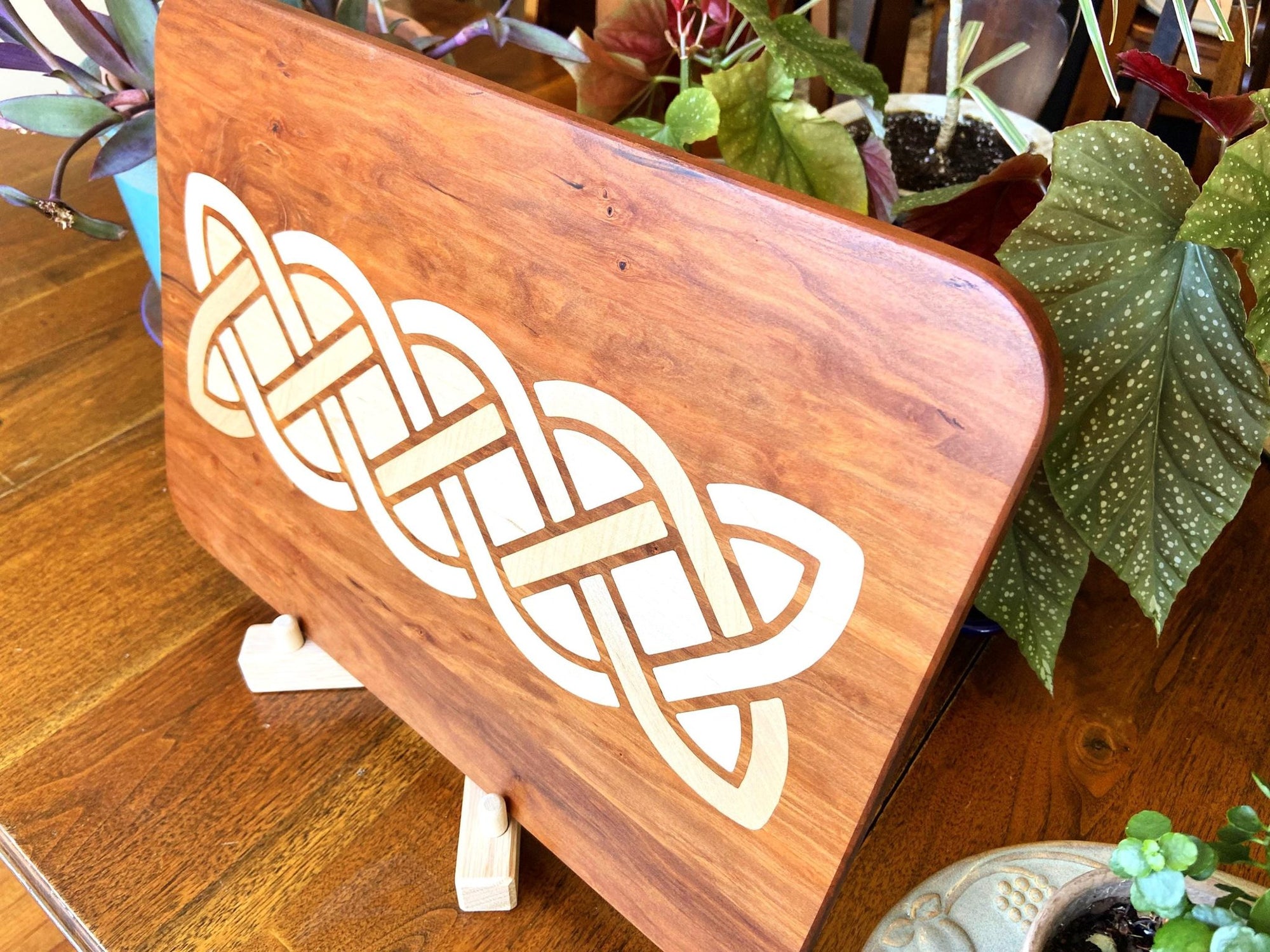 Cherry charcuterie board with complex Celtic knot inlay on White Oak wood