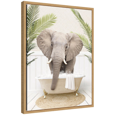 Framed canvas art titled Sylvie Elephant Front Palm Bathtub by Amy Peterson showing an elephant sculpture in front of a palm leaf on canvas