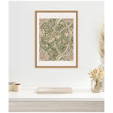 Framed William Morris Windrush 1883 floral poster with cream, green, and brown foliage patterns on a white wall above a minimalist wooden table with vases and dried plants.