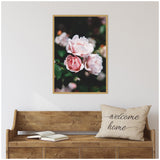 Light pink rose cluster with soft petals and green foliage in a natural dark background, framed and hung above a rustic wooden bench with a 'welcome home' pillow.