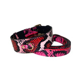 Coiled dog collar and matching leash with bold fuchsia, light pink, red, and black snake print pattern and gold-toned hardware details.