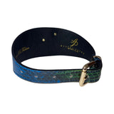 Blue and green snakeskin textured dog collar with a gold buckle and black leather lining, featuring stamped gold branding on inner side.