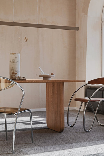 Oval solid wood dining table with chestnut wood finish and custom solid wood legs