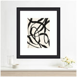 Abstract art with bold black twisting lines on a white background framed in black and hung on a white wall above a minimalist white shelf with a candle and a small vase of white flowers.