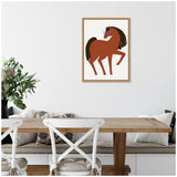 Framed minimalist illustration of a brown horse wearing blue glasses with a dark mane, hanging above a wooden dining table with white chairs and neutral cushions.
