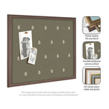 Rectangular pinboard with olive green fabric featuring small white botanical motifs, framed in medium wood tone, displaying two black-and-white photos held by tan pins.