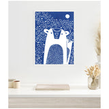 Framed linocut artwork showing two stylized white bears with blue patterned bodies against a dark blue background filled with white leaf outlines and a full moon.