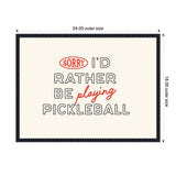Framed wall art with black and red text "Sorry I'd rather be playing pickleball" on a cream background, dimensions labeled 24 by 18 inches.