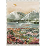 Framed canvas painting of a serene landscape with soft green mountains, a calm water body, muted peach sky, and colorful wildflowers in the foreground.