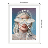 Portrait of a woman with platinum blonde hair wearing a lacy garment, a large white moth covers her eyes, a halo of moon phases and stars encircles her head against a starry blue background.