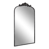 Tall rectangular mirror with arched top and ornate black decorative crest on top center, featuring a thin black frame.