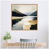 Modern abstract landscape painting of a mountain lake with muted beige, blue, and black tones, framed in light wood and hung above a minimalist desk setup.