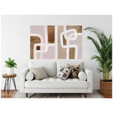 Two framed abstract canvases with rhythmic white lines over soft brown and muted pink backgrounds hang above a white sofa adorned with neutral and patterned cushions in a minimalist living room.