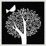 Black and white linocut of a stylized tree with oval leaves and a simple bird perched above, framed in a white bordered frame.