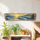 Long, narrow wooden wall art depicting a coastal scene with crashing blue waves, a golden sunset, and distant sailboats, hung above a plant-decorated table in a living room.