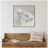 Soft-focused side profile of a white sheep with curly wool and a calm expression against a muted beige background in a square frame.