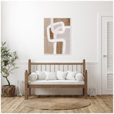 Abstract brown and beige rhythmic lines painting above a wooden framed bench with white cushions, set in a minimalistic room with a potted plant and jute rug.