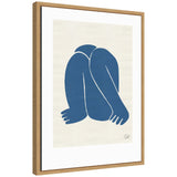 Minimalist blue abstract figure curled up with head down, contrasted on a beige canvas and enclosed in a natural wood frame.