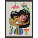 Stylized black cat with pink cheeks lounging on a green and blue striped round table adorned with a colorful floral teapot and macarons, under a pink flower lamp and hanging plant.