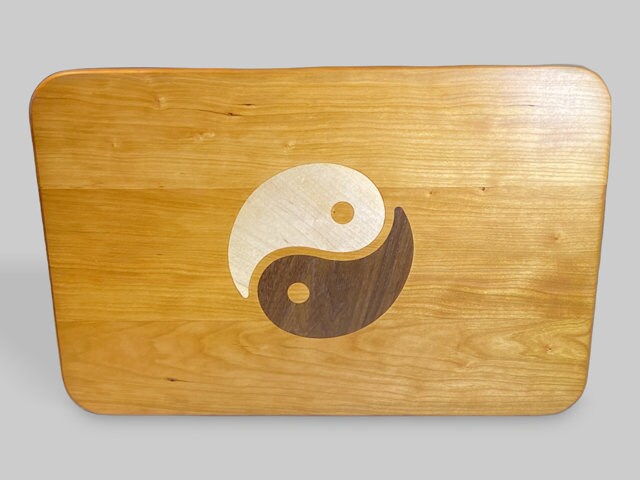 Cherry wood charcuterie board with Yin Yang inlay of Maple and Peruvian Walnut