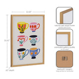 Print featuring six ceramic cups decorated with botanical patterns in yellow, pink, red, black, blue, and white, framed in a gold-painted natural oak wood frame.