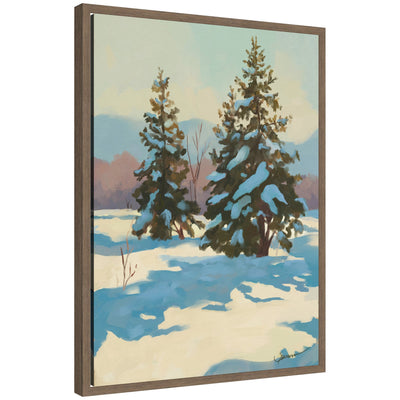 Framed canvas print showing a winter scene with snow-covered pine trees and pastel sky, presented in walnut-colored Sylvie frame.