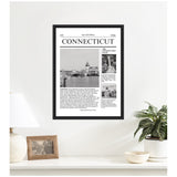 Black-framed wall art styled like a newspaper front page titled 'Connecticut' with a large black and white photo and two smaller images, hanging above a white shelf with a lamp, photo frame, and potted plant.