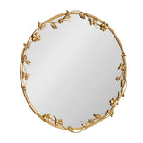 Round wall mirror with a gold metal frame featuring delicate floral and butterfly accents arranged around the edge in an ornate design.