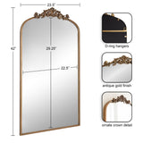 Tall arch-shaped mirror with an antique gold frame, featuring an ornate carved crown detail at the top and D-ring hangers on the reverse side.