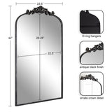 Tall arched mirror with antique black finish frame, featuring ornate crown detail at the top and D-ring hangers on the back for mounting.