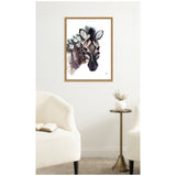 Framed canvas print of a stylized zebra head with purple stripes and white flowers on its mane, hanging on a white wall above a small side table between two cream-colored chairs.